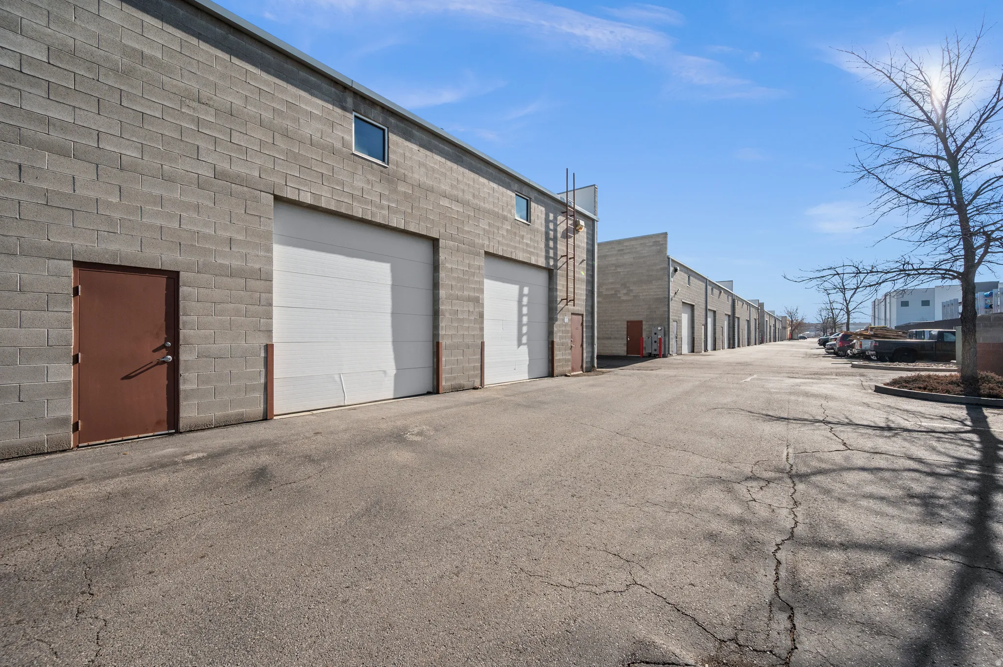 View of asphalt road with community garages and a residential view