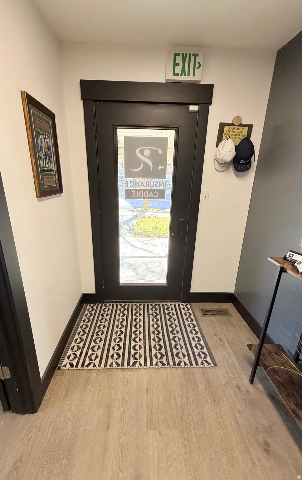 Entryway with wood finished floors and baseboards