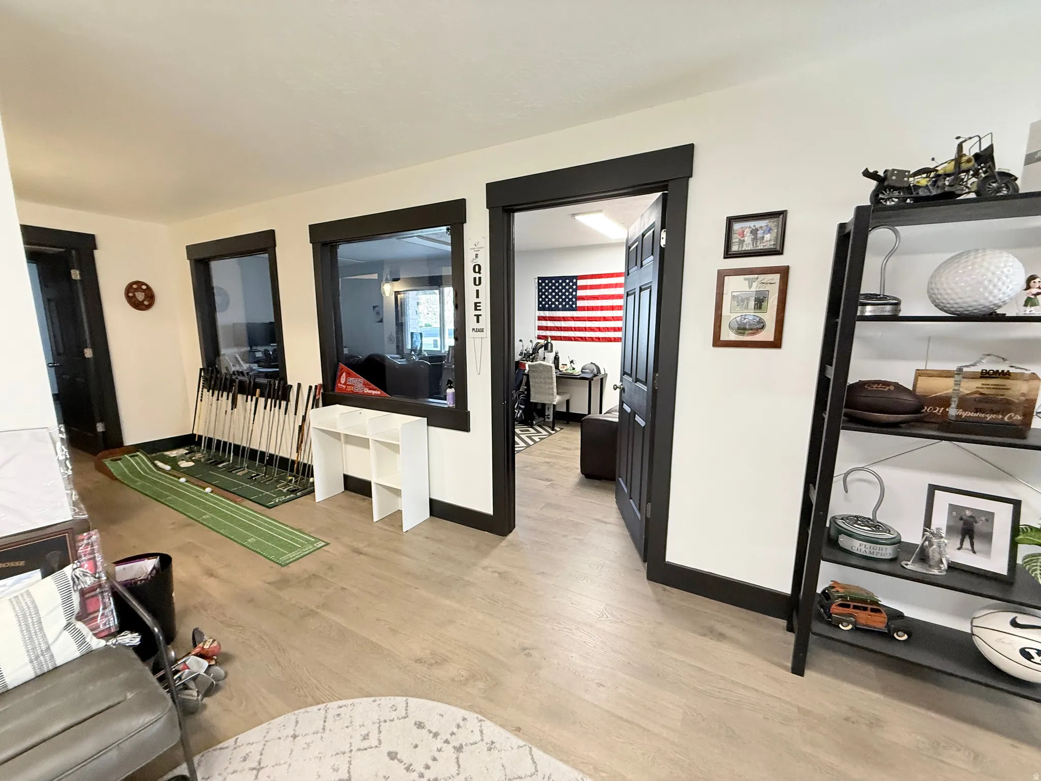 Living room featuring light wood-style flooring and baseboards