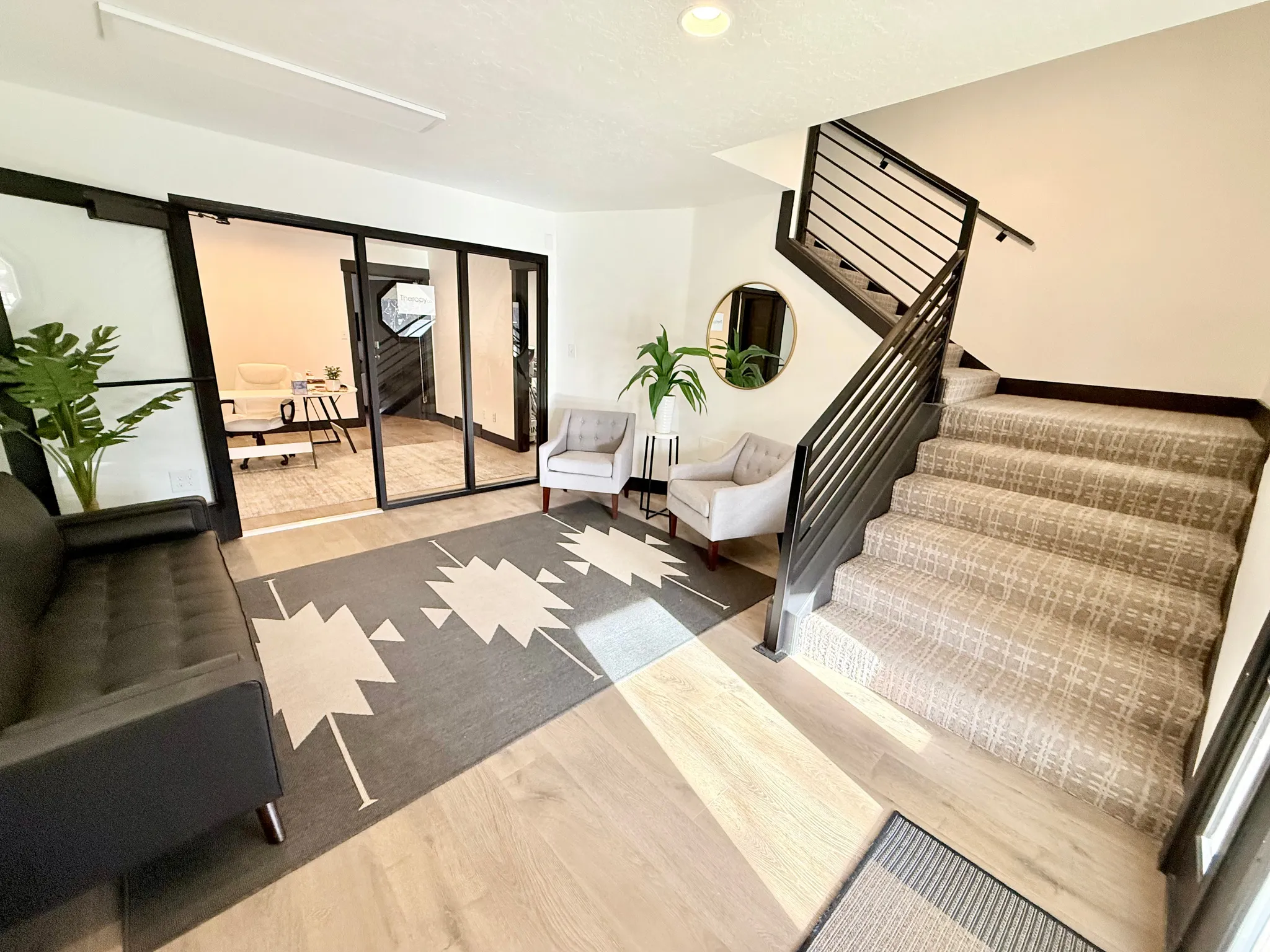 Stairway with wood finished floors and recessed lighting