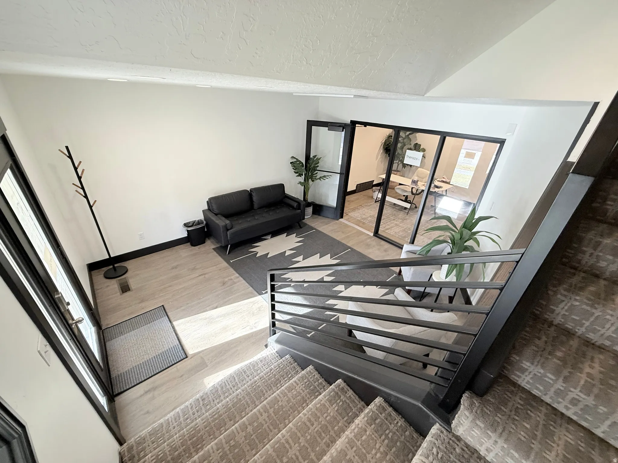 Stairs featuring wood finished floors and baseboards