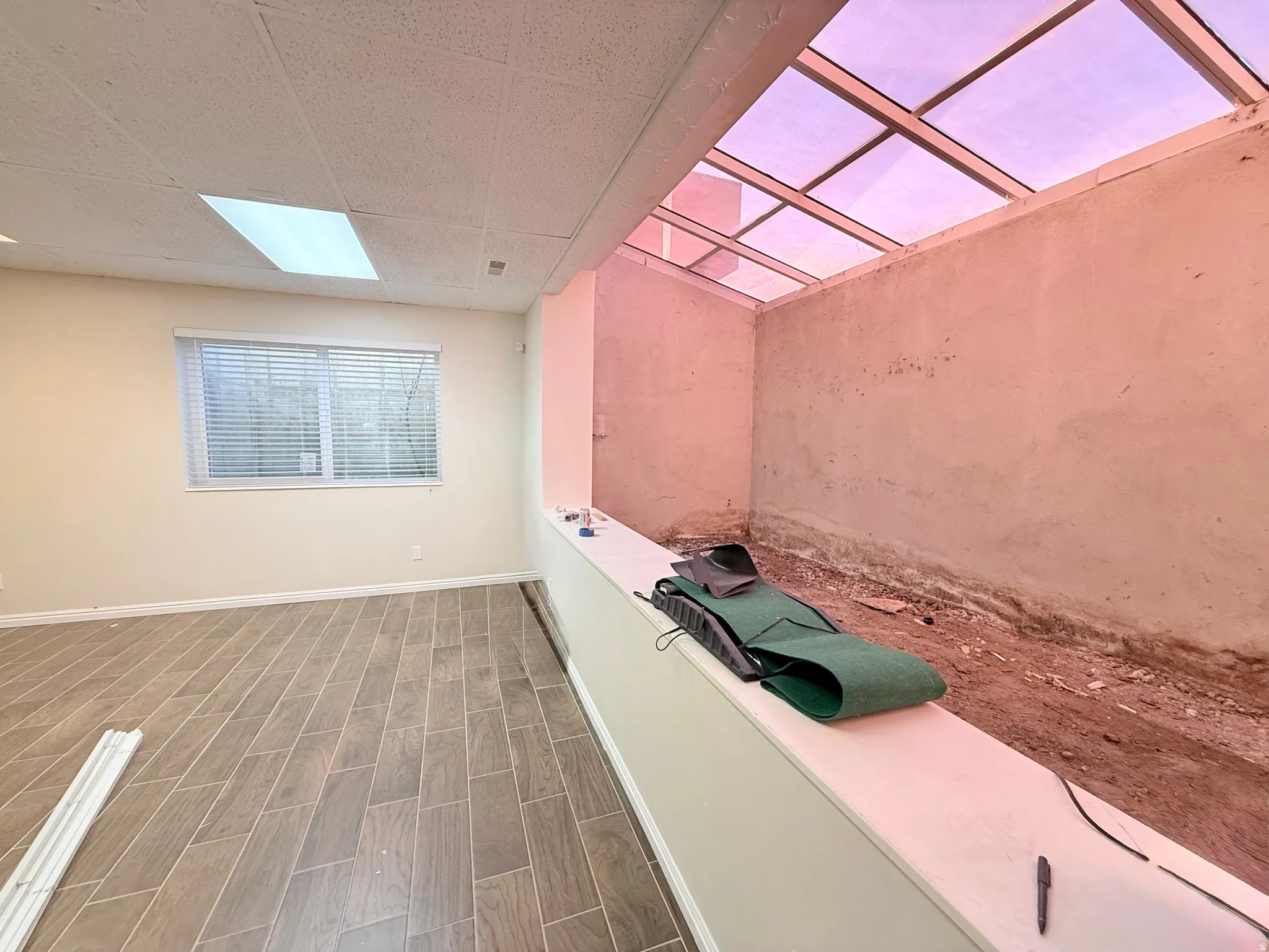 Interior space with wood tiled floors and a drop ceiling