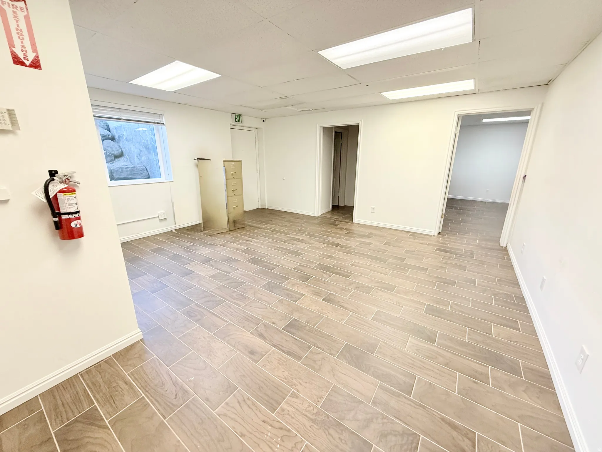 Below grade area with wood tiled floors and a paneled ceiling
