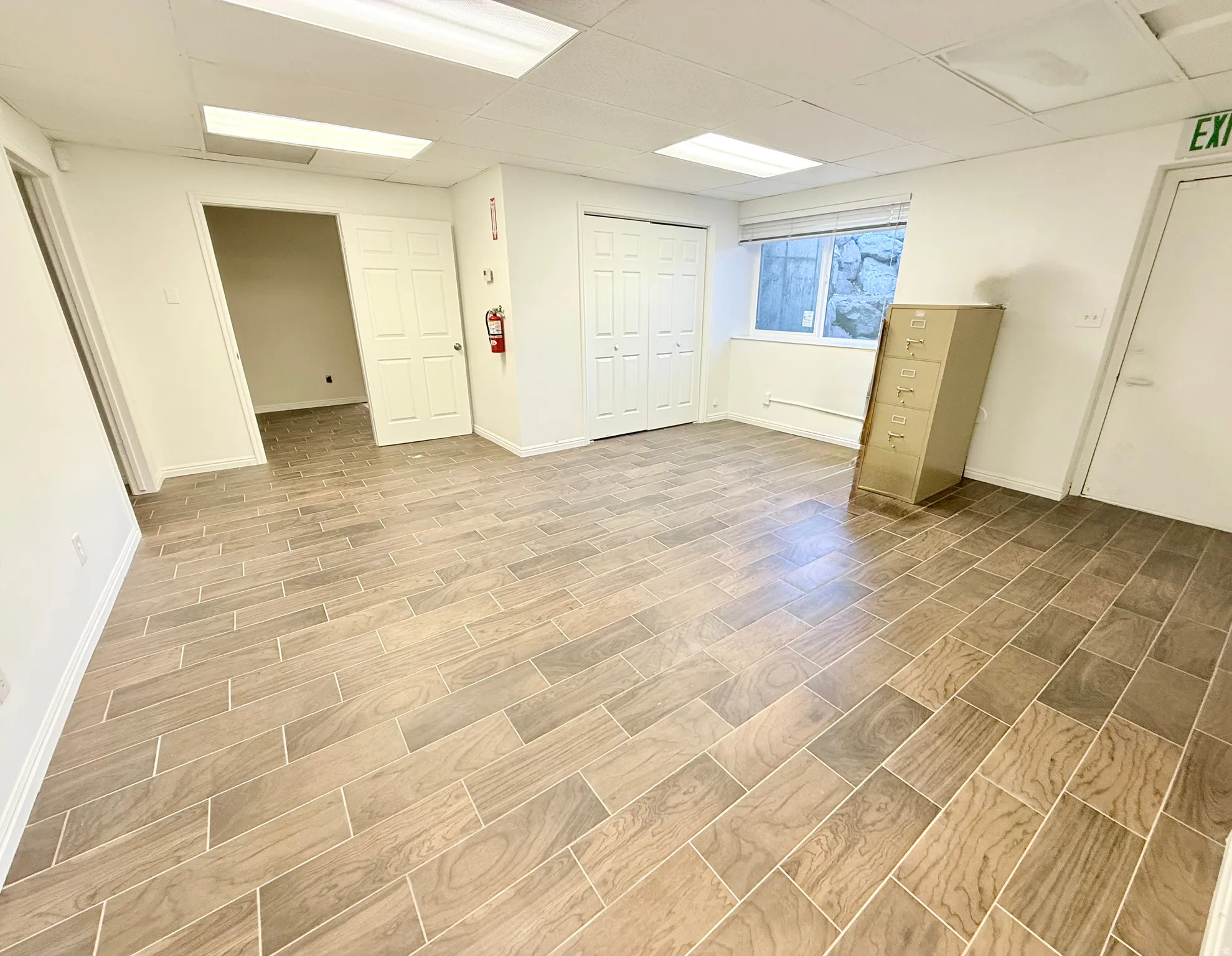 Basement featuring a paneled ceiling and wood tiled floors