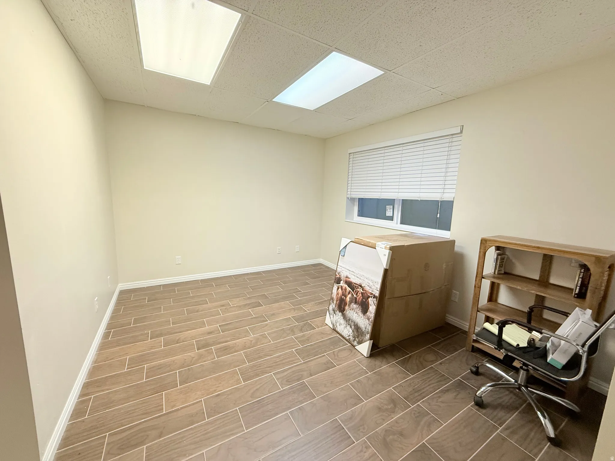 Laundry area featuring a paneled ceiling and wood tiled floors