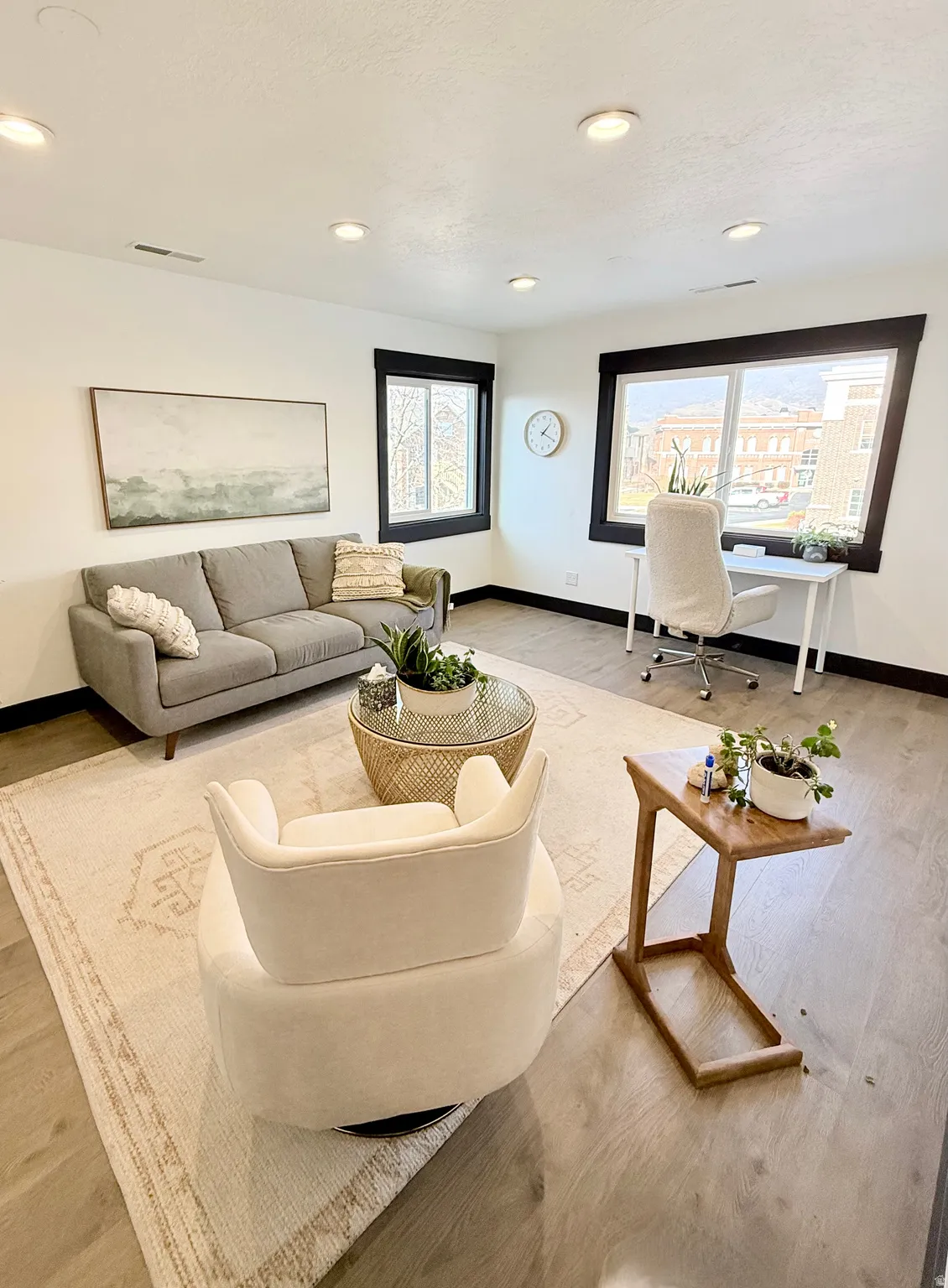 Living area with an office area, wood finished floors, and recessed lighting