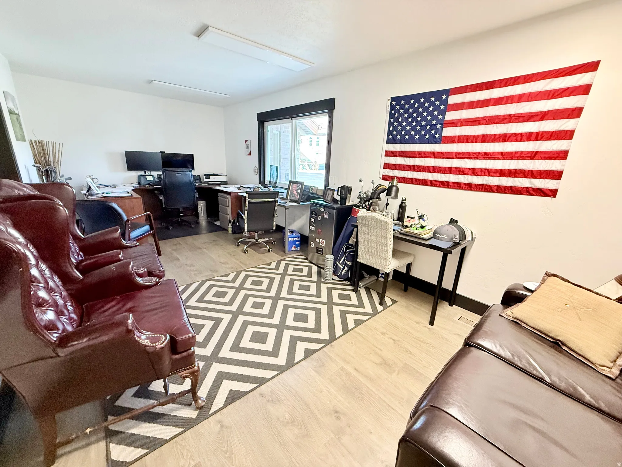 Office space featuring light wood-style flooring and baseboards