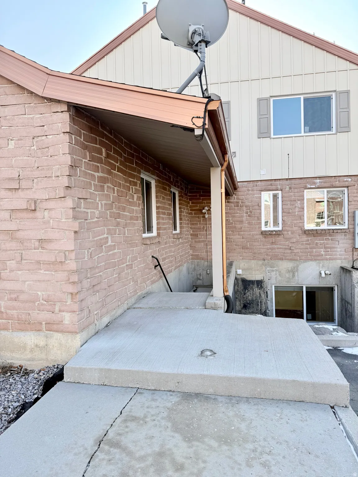 Back of house featuring a patio area and brick siding