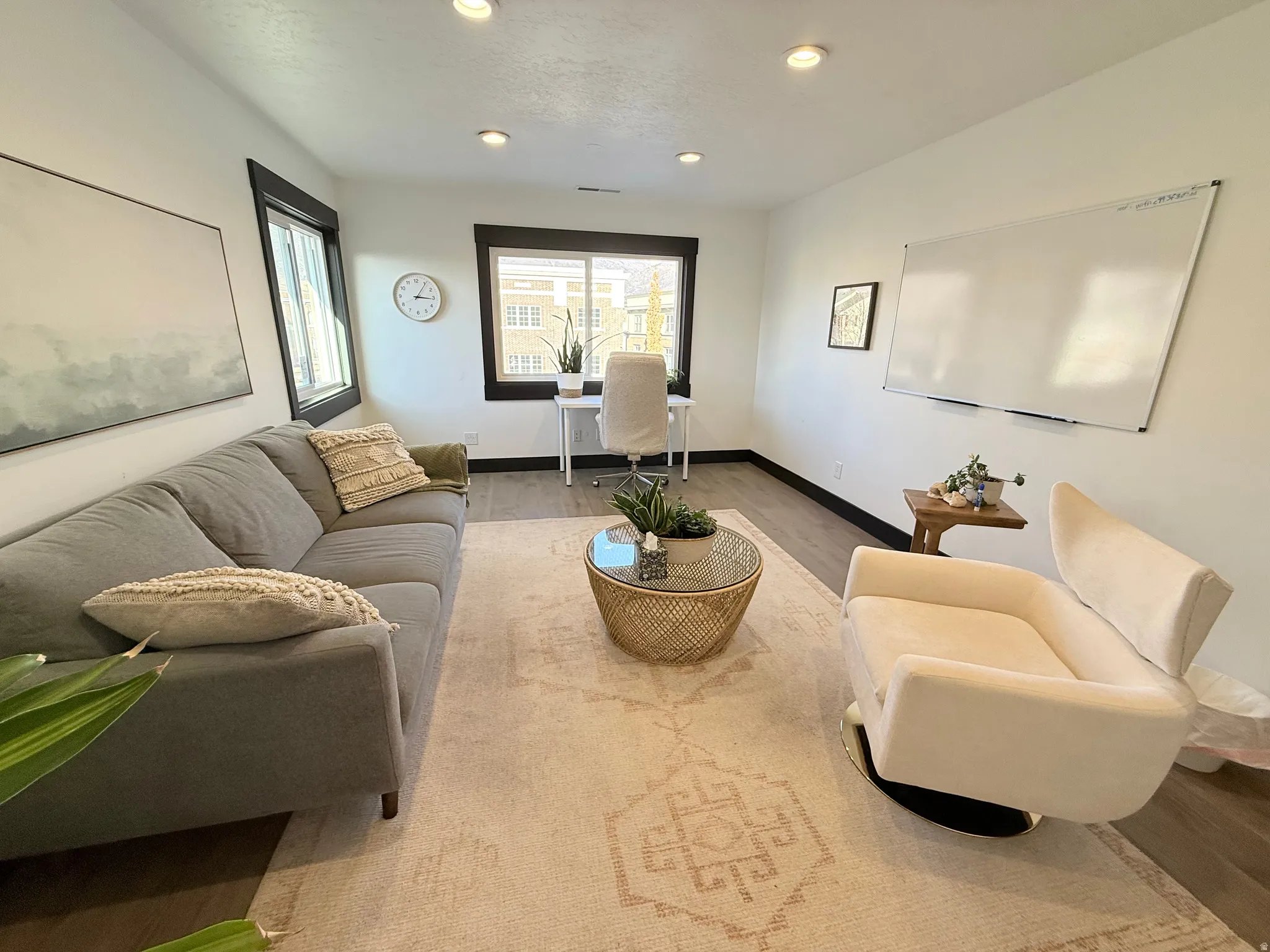 Living area with wood finished floors and recessed lighting