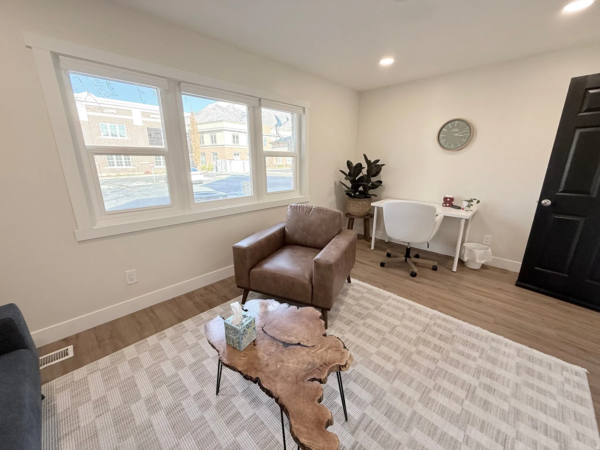 Sitting room with wood finished floors and recessed lighting