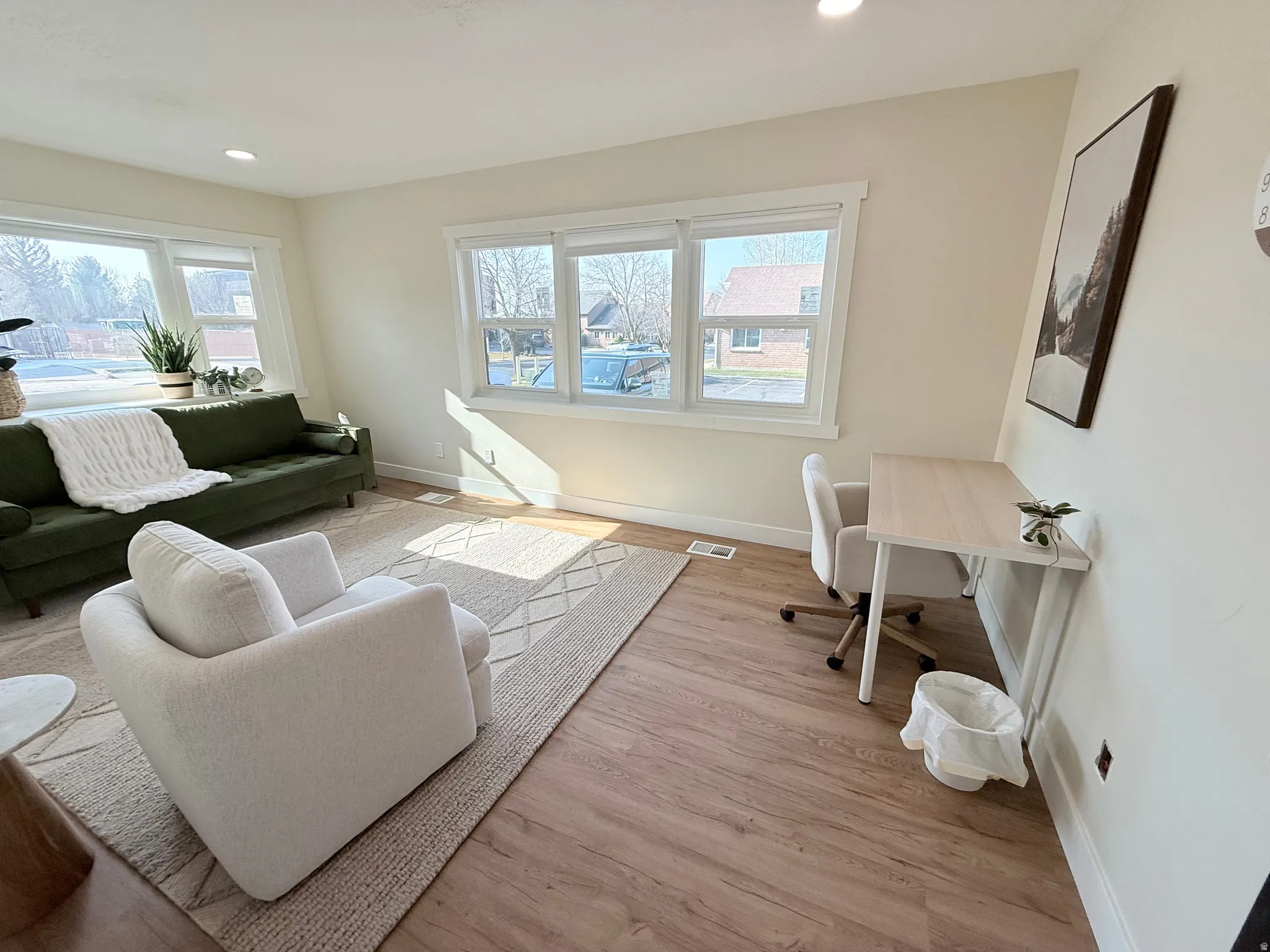 Office space with light wood finished floors and recessed lighting