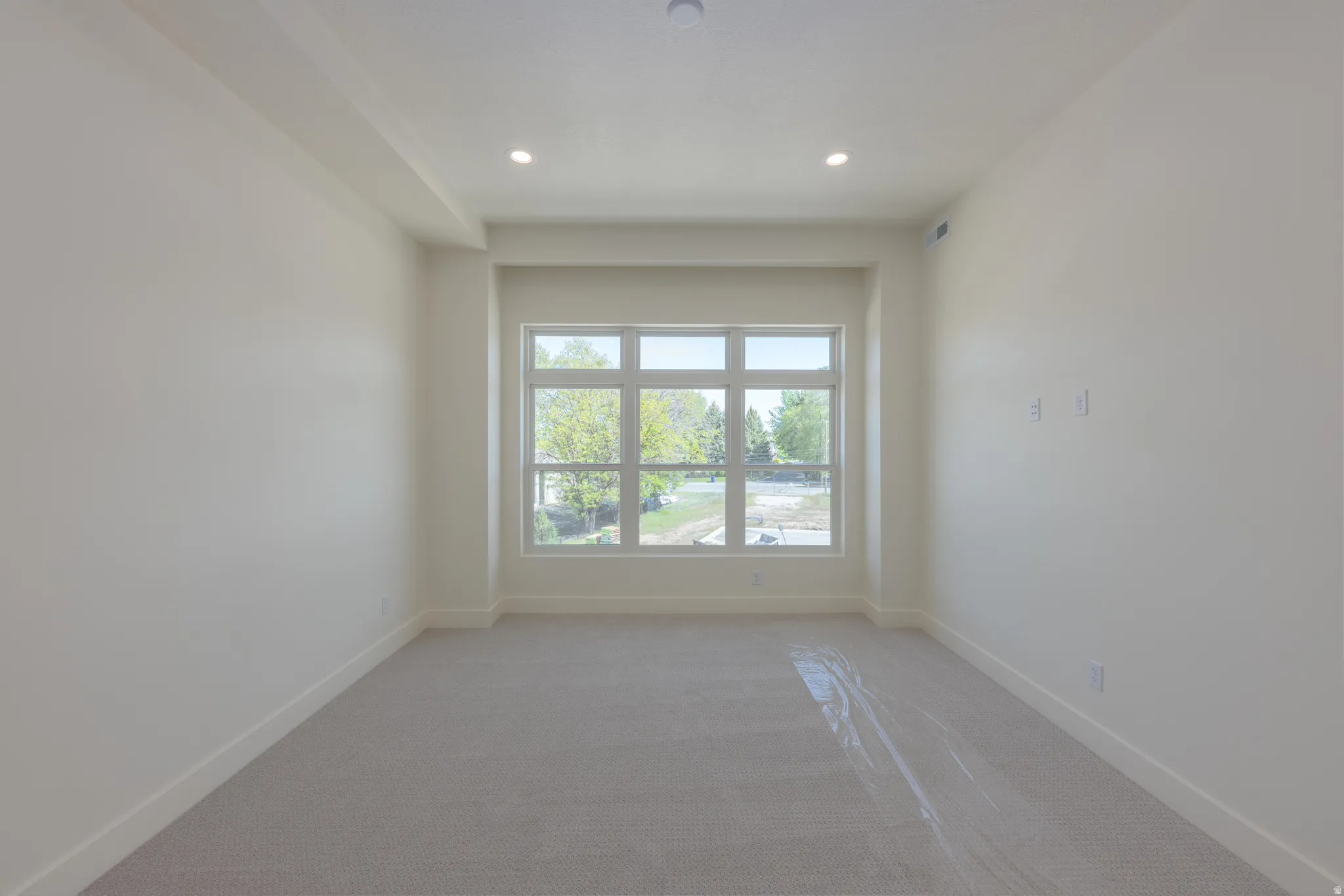 Spare room with light colored carpet and recessed lighting
