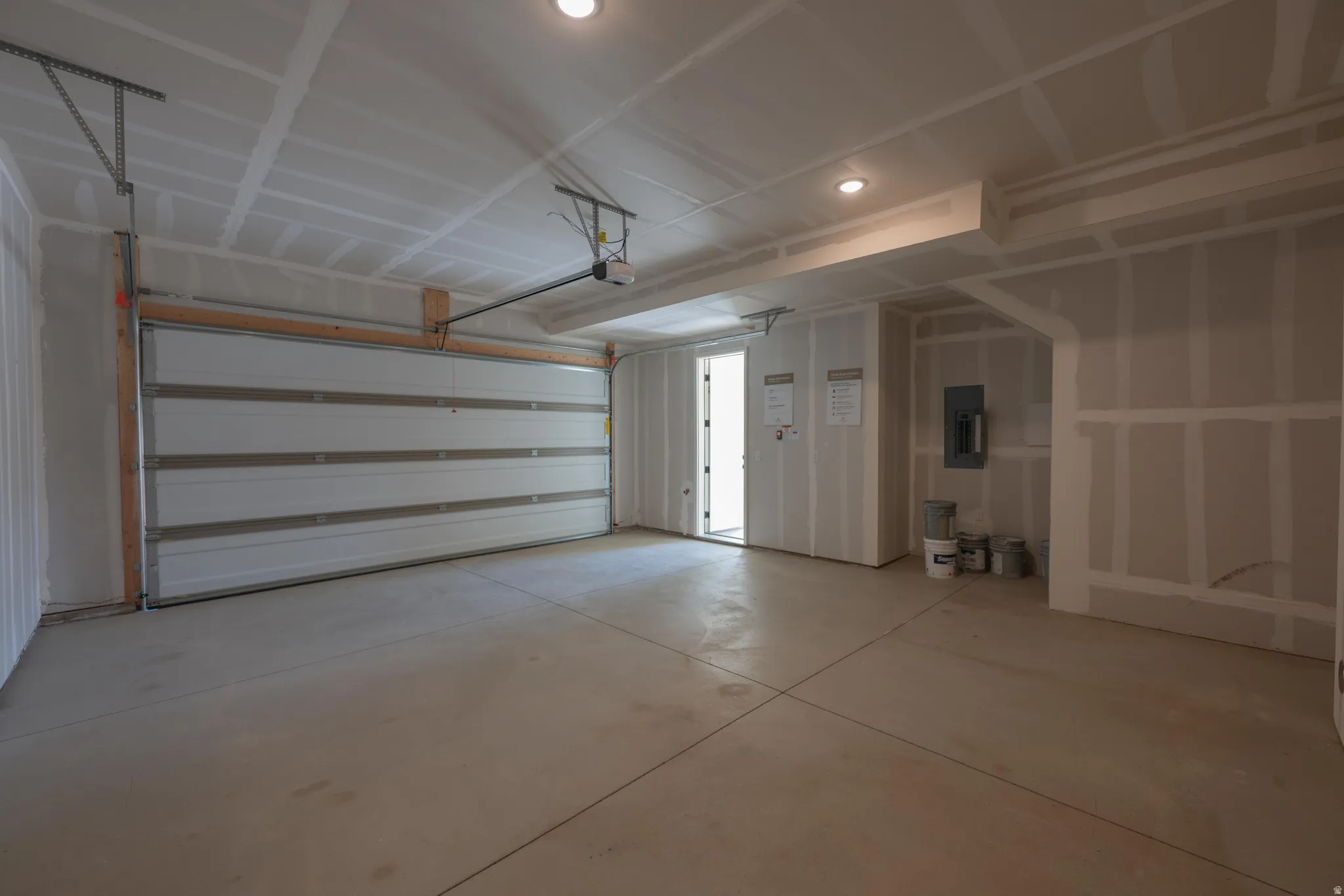 Garage with electric panel and recessed lighting