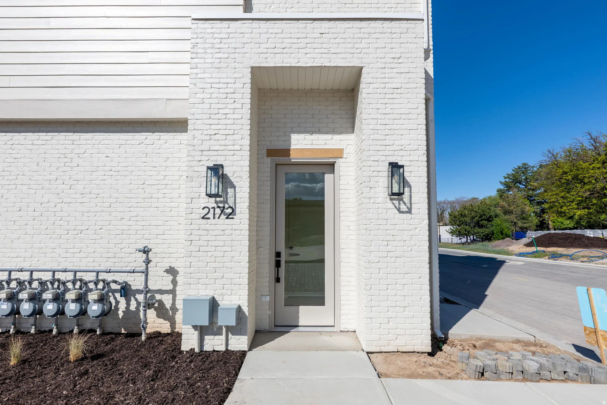 View of exterior entry with brick siding
