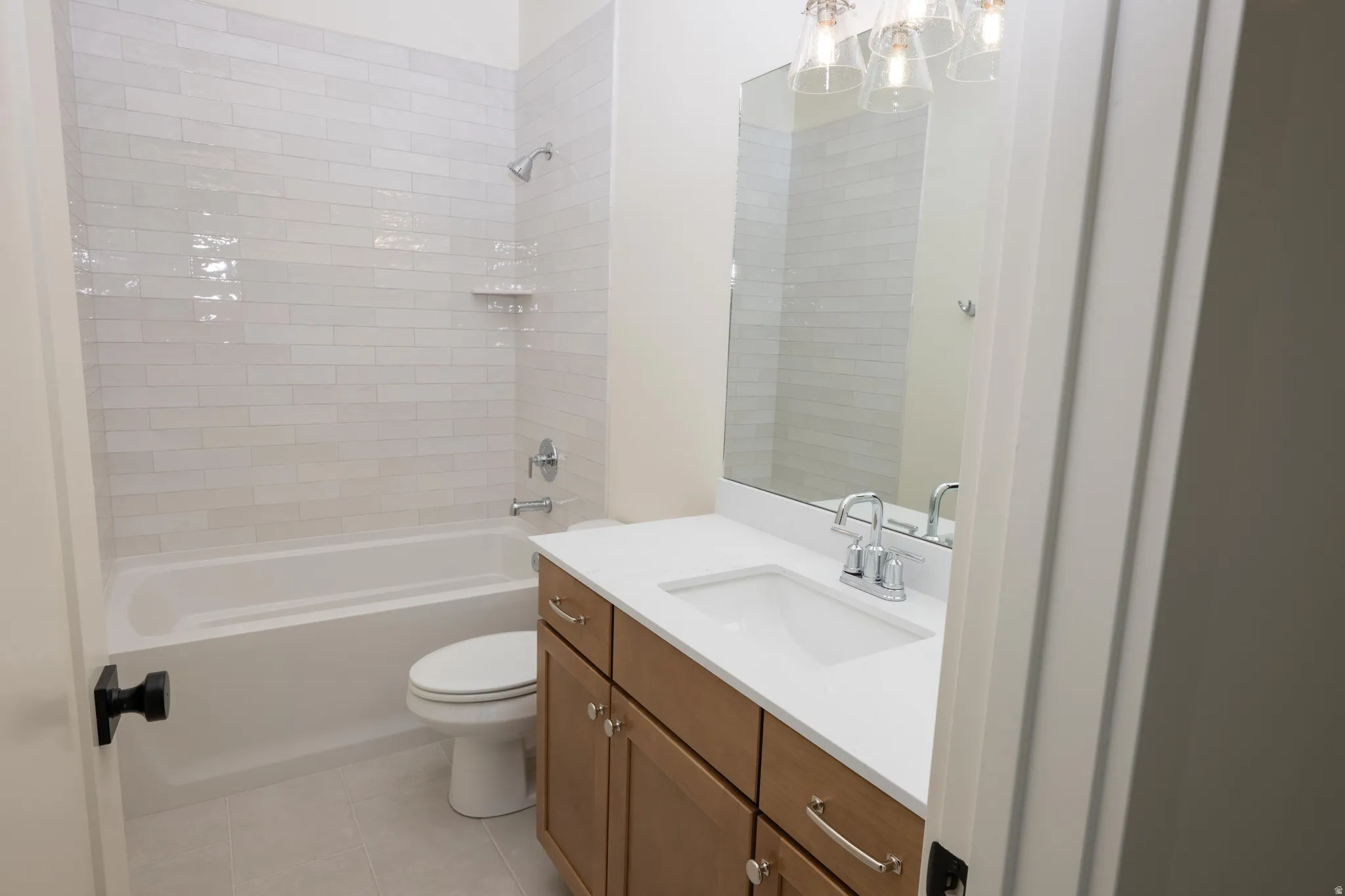 Bathroom with vanity,  shower combination, and light tile patterned flooring