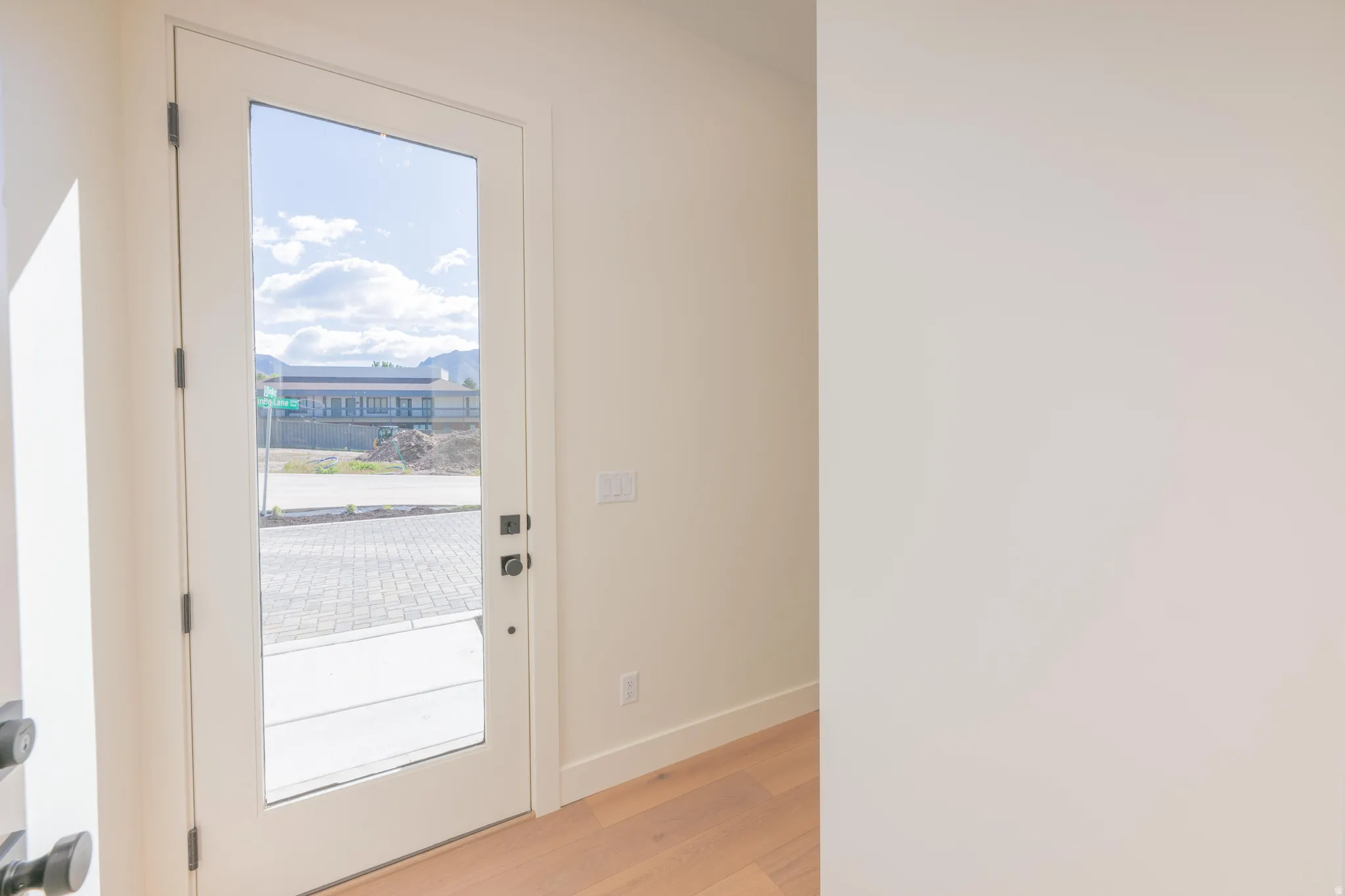 Entryway with wood finished floors and a mountain view