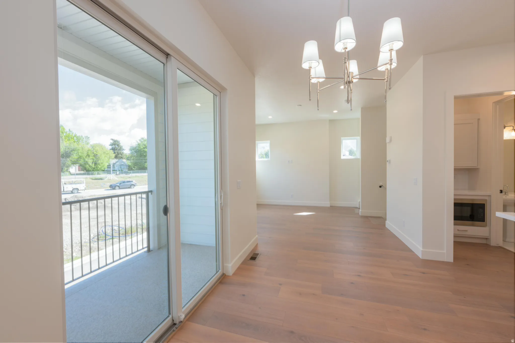 Unfurnished dining area with a chandelier and light wood-style flooring
