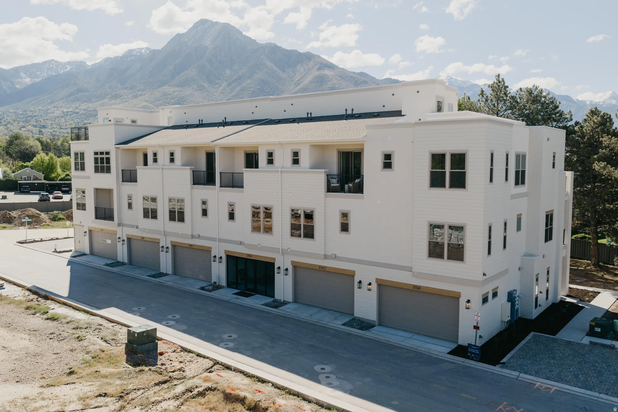 View of building exterior featuring a mountain view and a garage