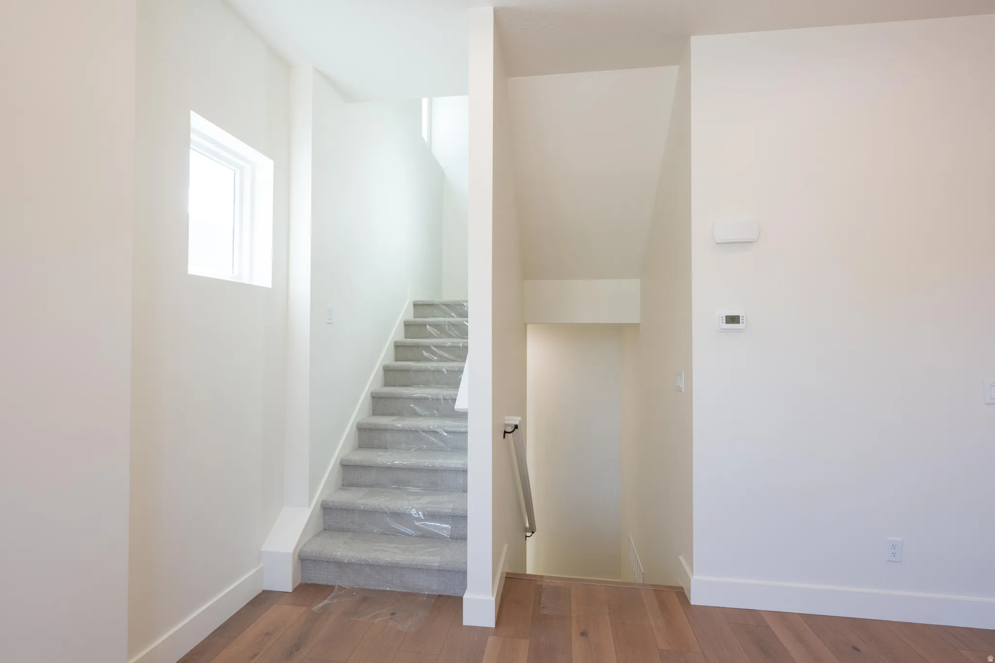 Staircase featuring baseboards and wood finished floors