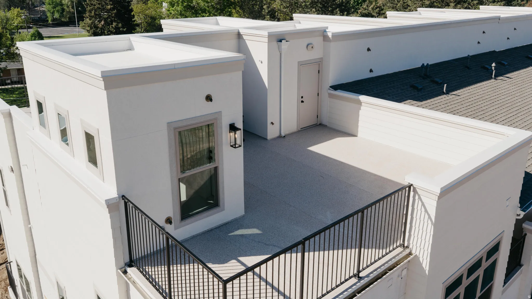 View of exterior entry featuring a patio area and stucco siding