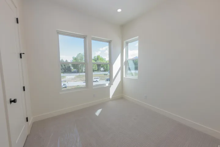 Carpeted empty room featuring baseboards and recessed lighting