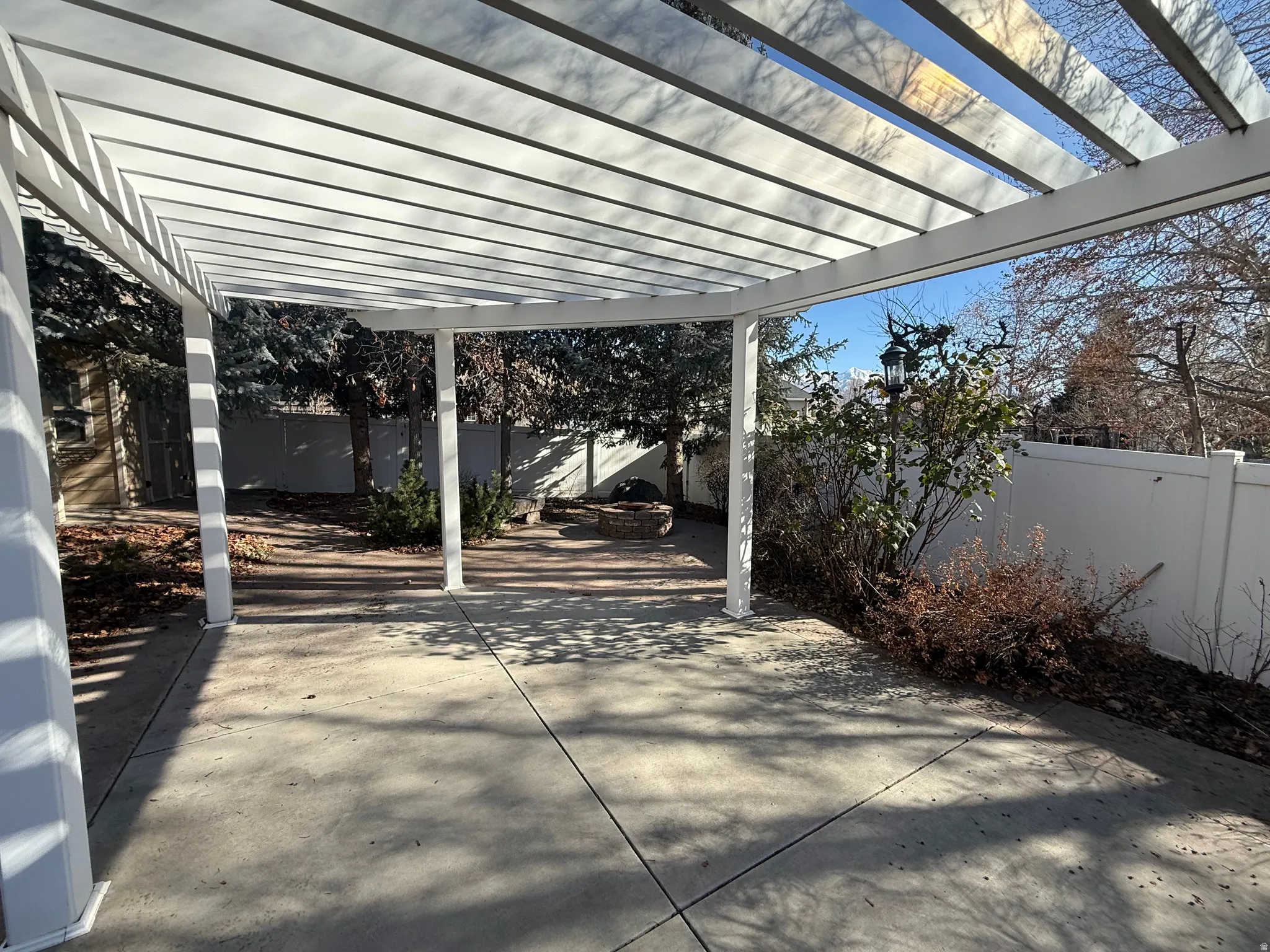Fenced backyard featuring a pergola and a patio