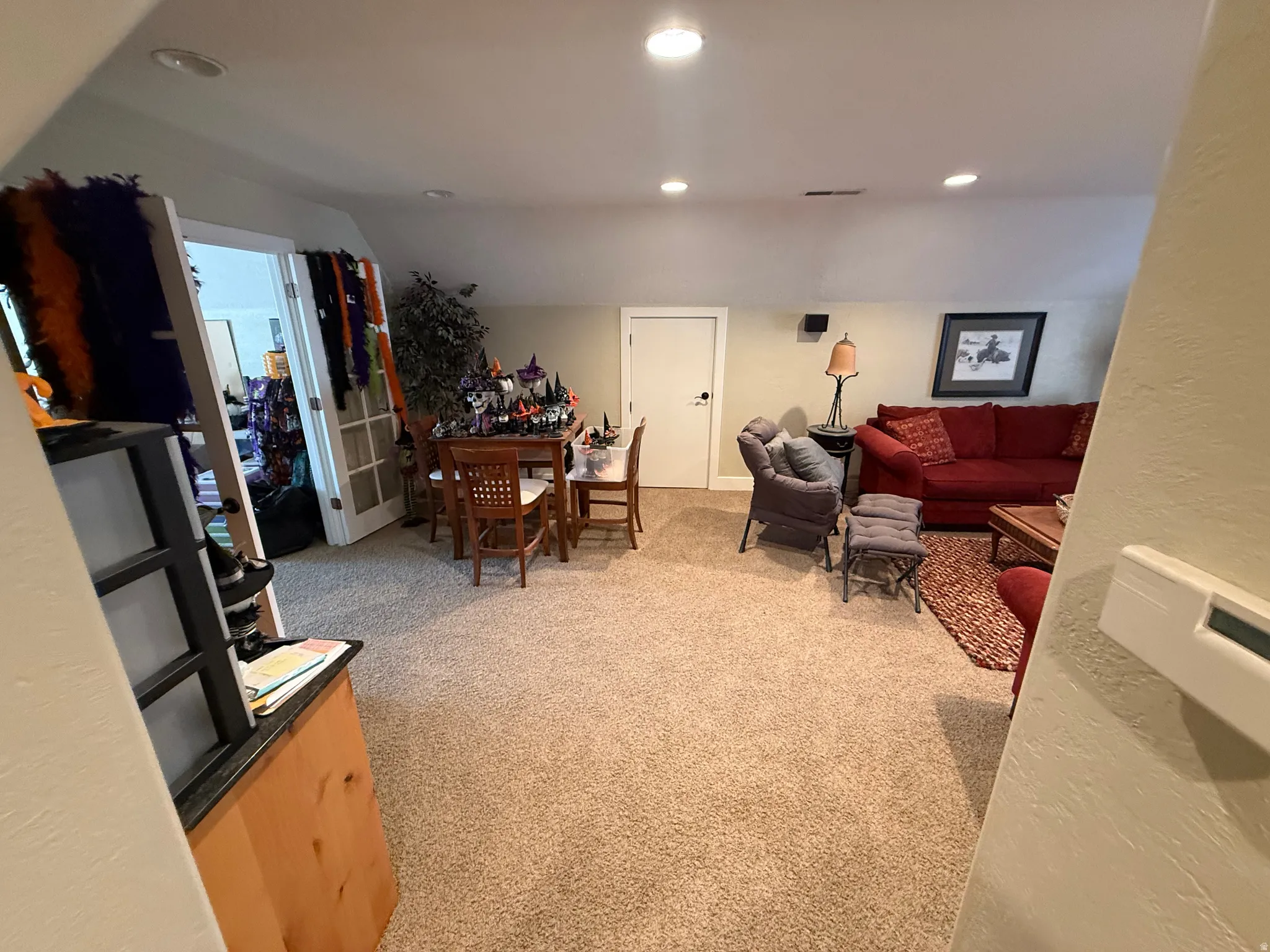 Living area featuring light carpet and recessed lighting