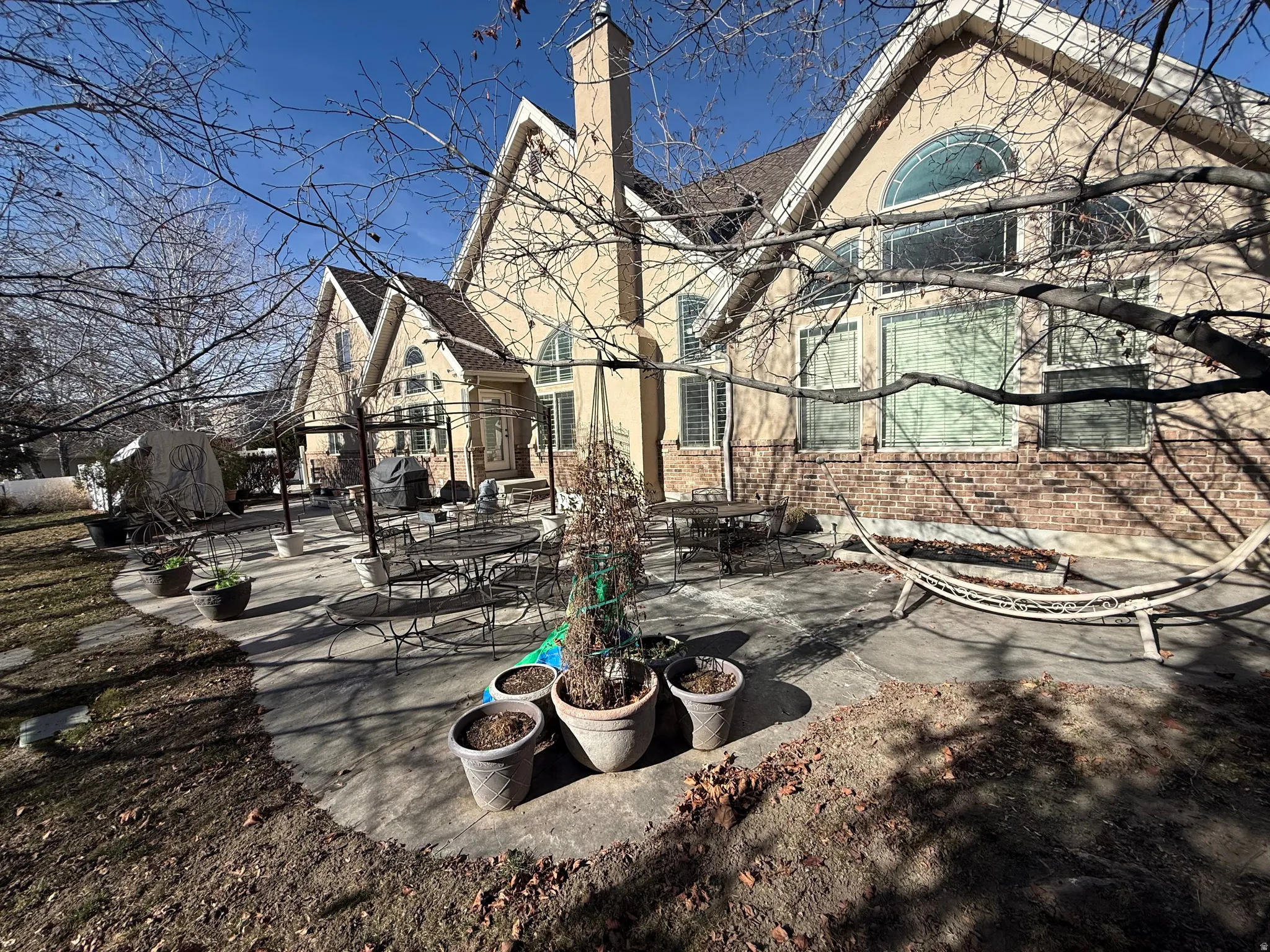 Rear view of property featuring a patio, a chimney, and outdoor dining space