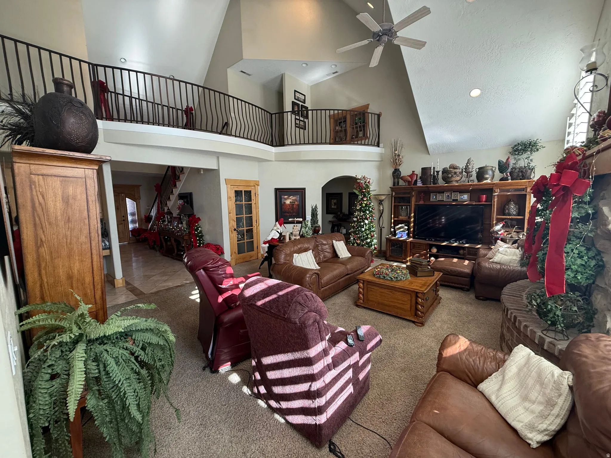 Living room featuring carpet, recessed lighting, a ceiling fan, and lofted ceiling