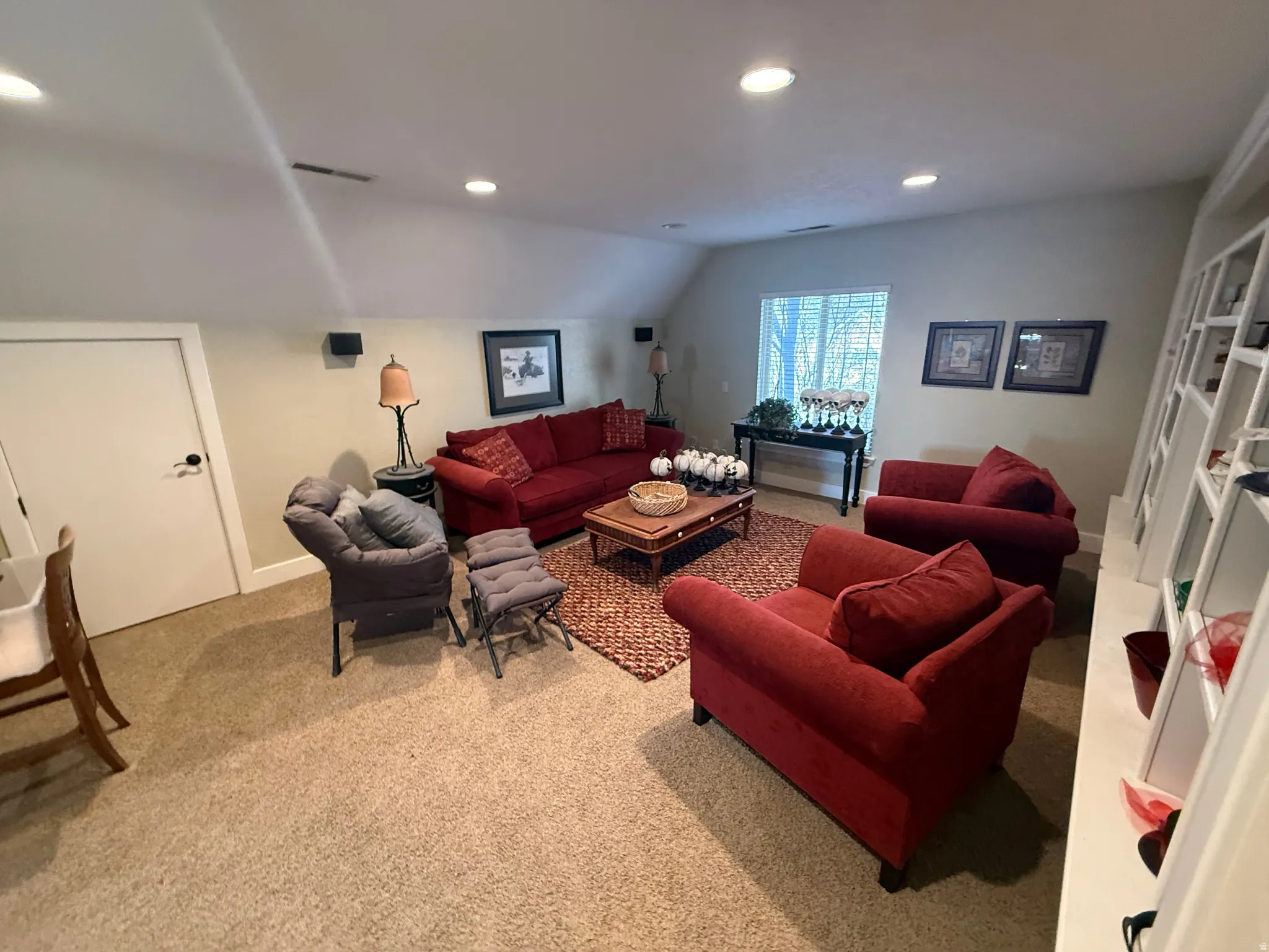 Living area featuring recessed lighting, carpet flooring, and lofted ceiling