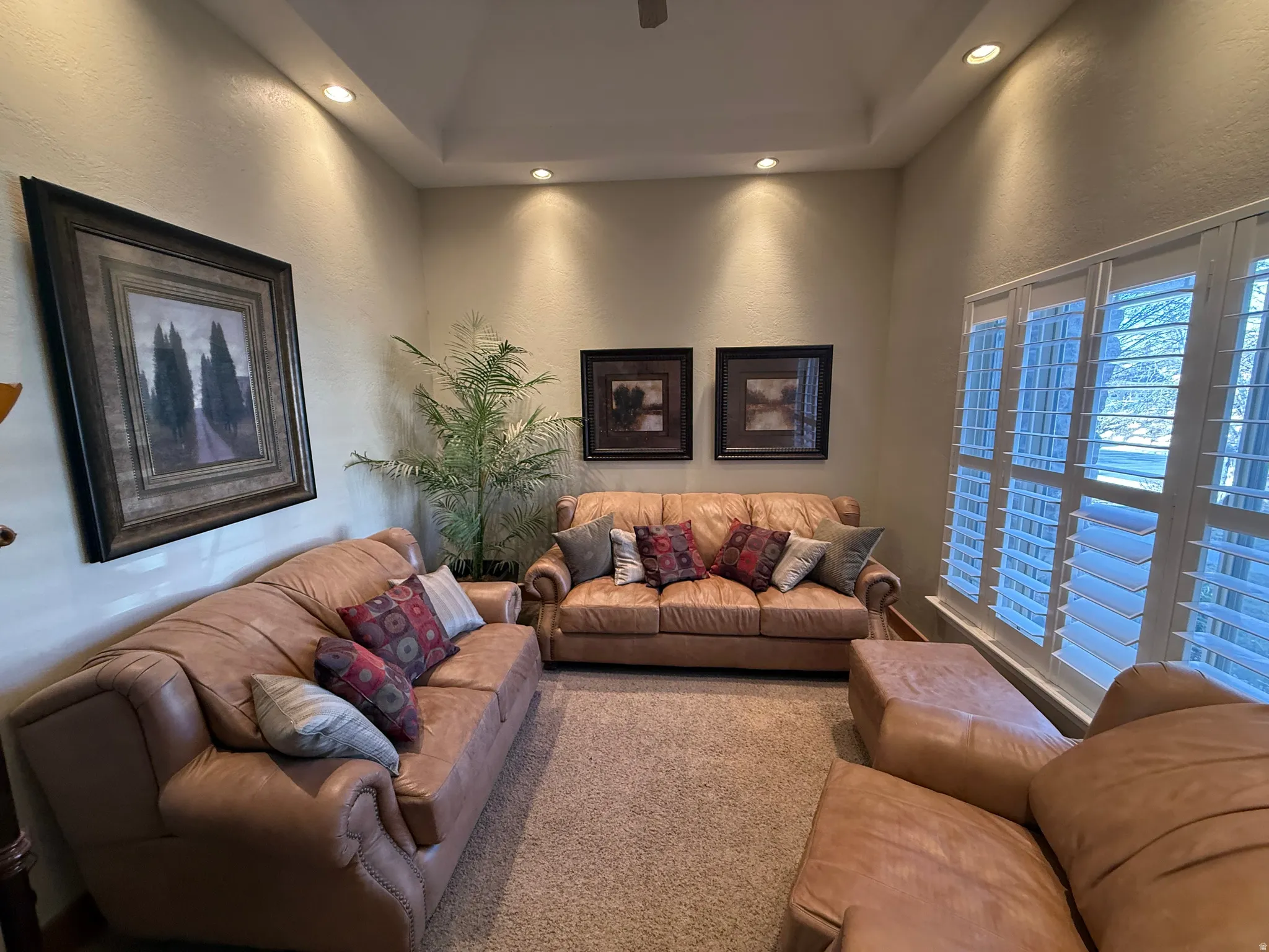 Living area featuring a textured wall and recessed lighting