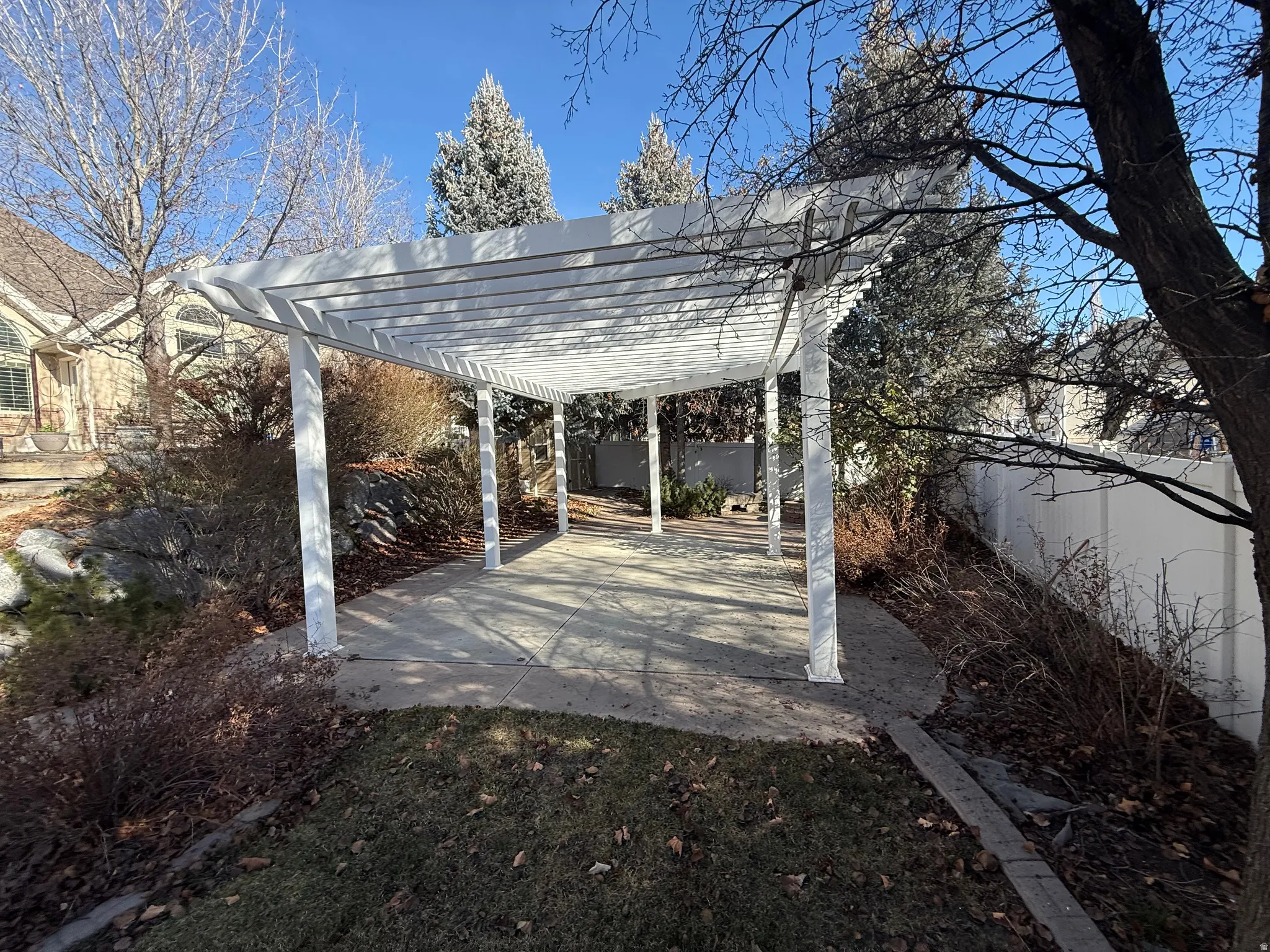 Fenced backyard featuring a pergola and a patio area