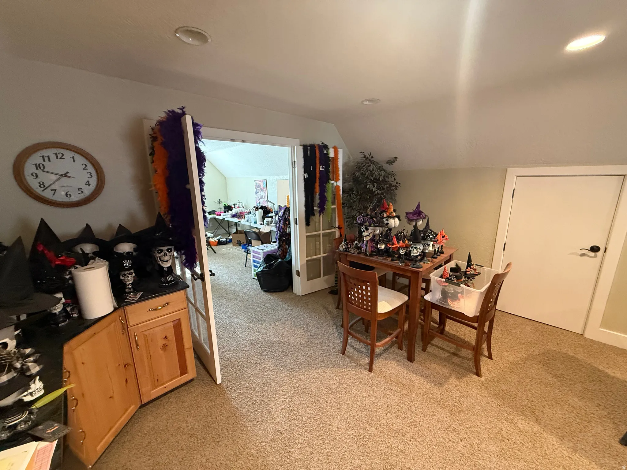 Dining space with light carpet, lofted ceiling, and recessed lighting