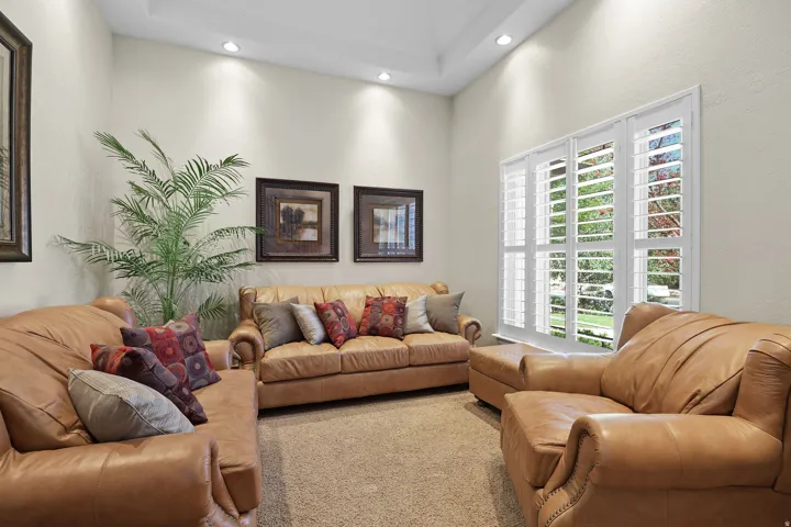 Living area with tray ceiling and recessed lighting