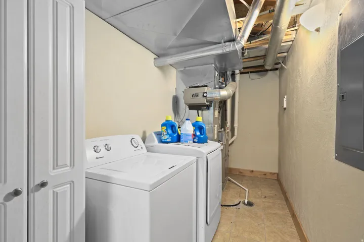 Dedicated laundry area featuring a top-load washing machine and front-load dryer