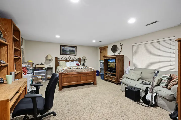 Spacious room featuring neutral carpeting and recessed lighting