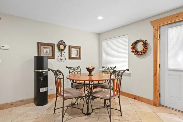Tiled flooring with natural wood baseboards and door trim