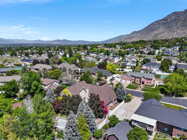 Expansive residential area featuring established homes, mature landscaping, and mountain backdrop