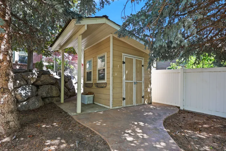Exterior storage shed with double doors and two windows