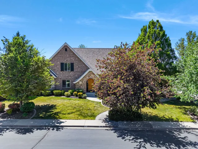 Brick and stone exterior featuring a prominent arched entryway