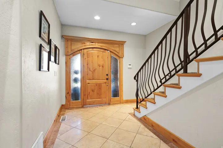 Arch-top wood entry door with frosted sidelights