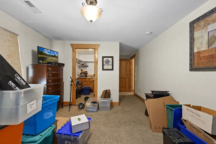Carpeted room featuring a ceiling-mounted light fixture, recessed lighting, and a wood-trimmed doorway