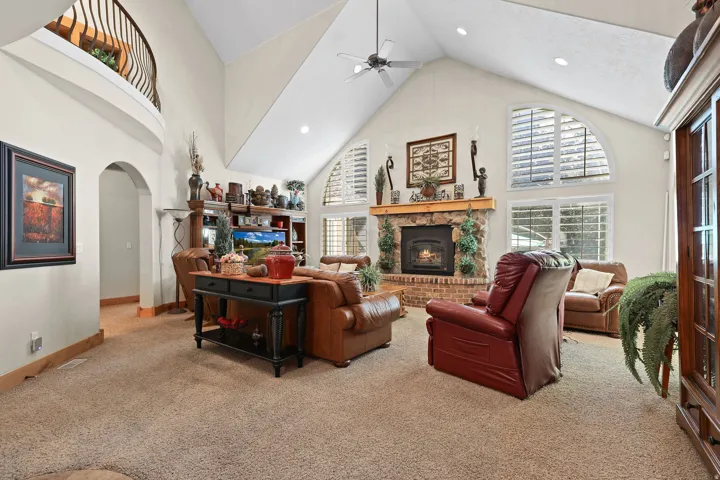 Living area with vaulted ceilings and a ceiling fan