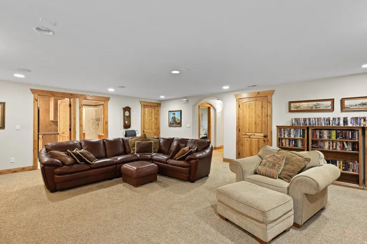 Spacious room featuring plush carpet flooring, recessed lighting, natural wood trim, natural wood doors, and built-in shelving