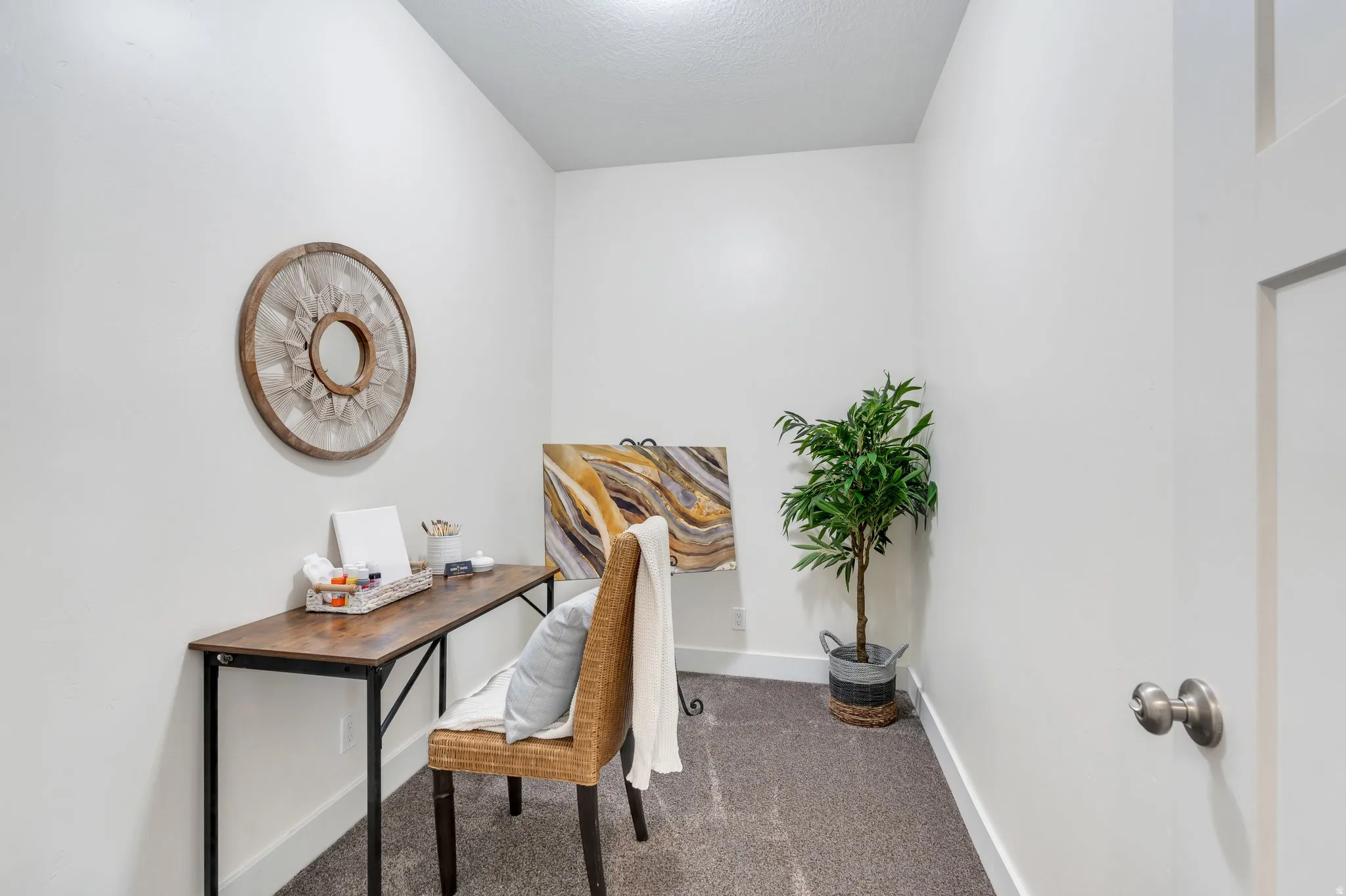 Office area with dark carpet and baseboards