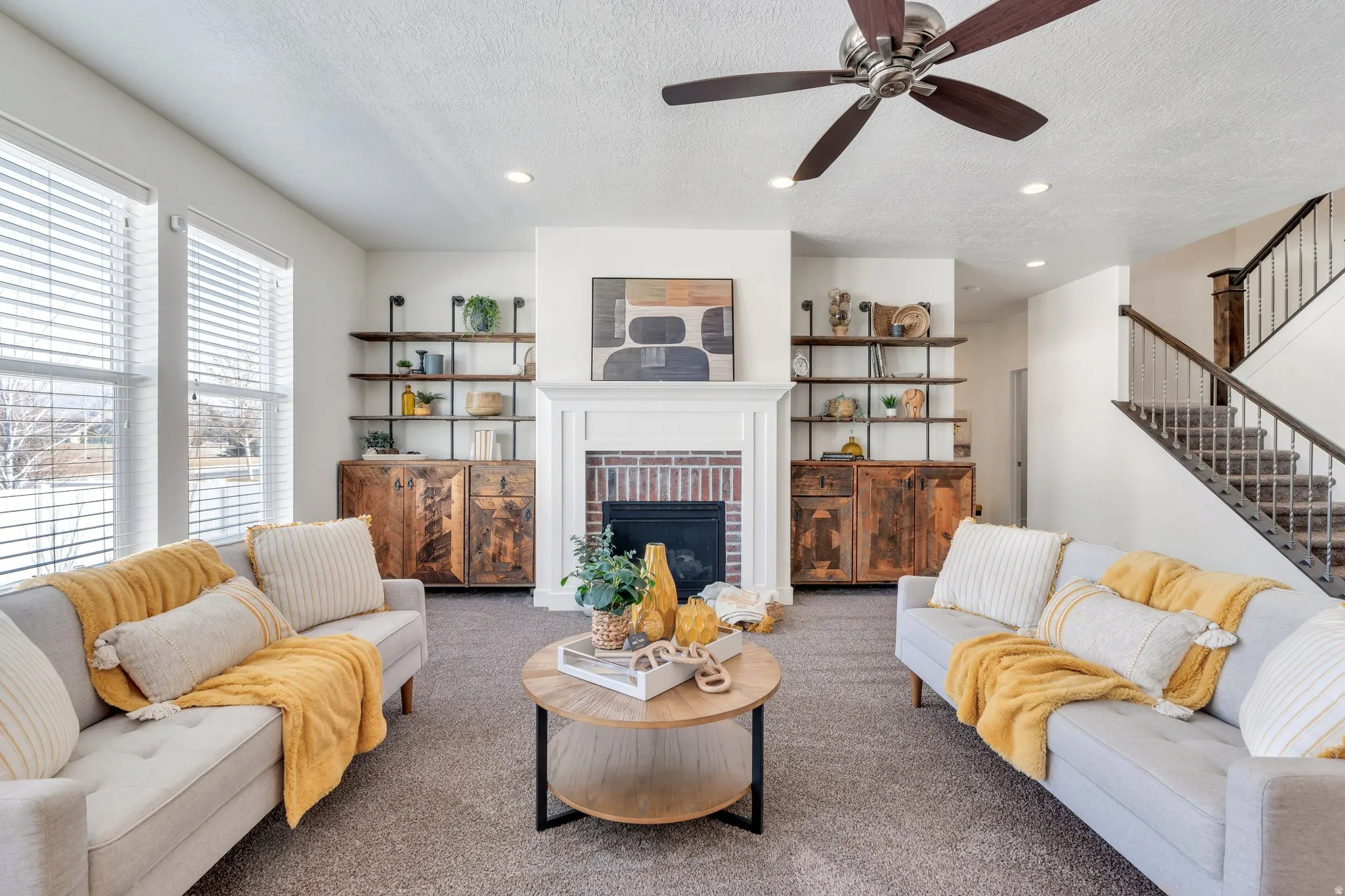 Living room with a brick fireplace, recessed lighting, carpet flooring, a textured ceiling, and ceiling fan