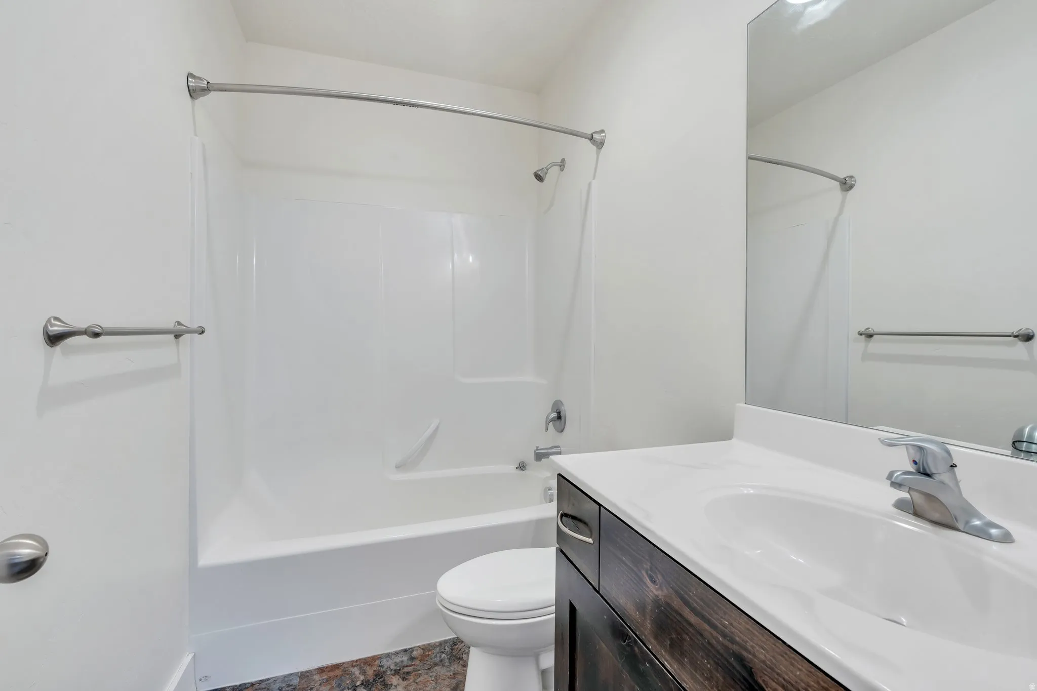 Bathroom featuring vanity and shower / bathtub combination