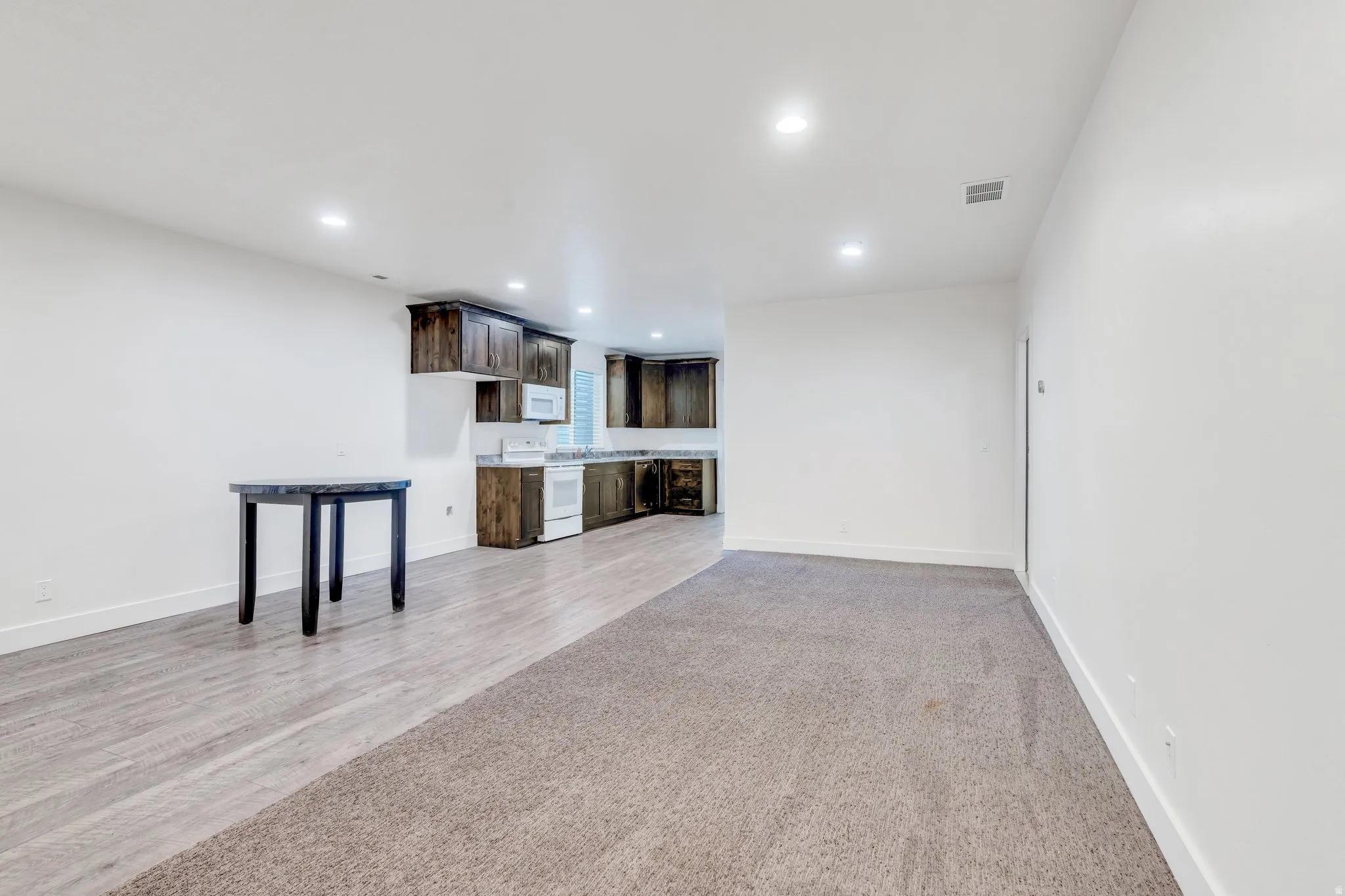 Unfurnished living room featuring recessed lighting and light wood-style floors