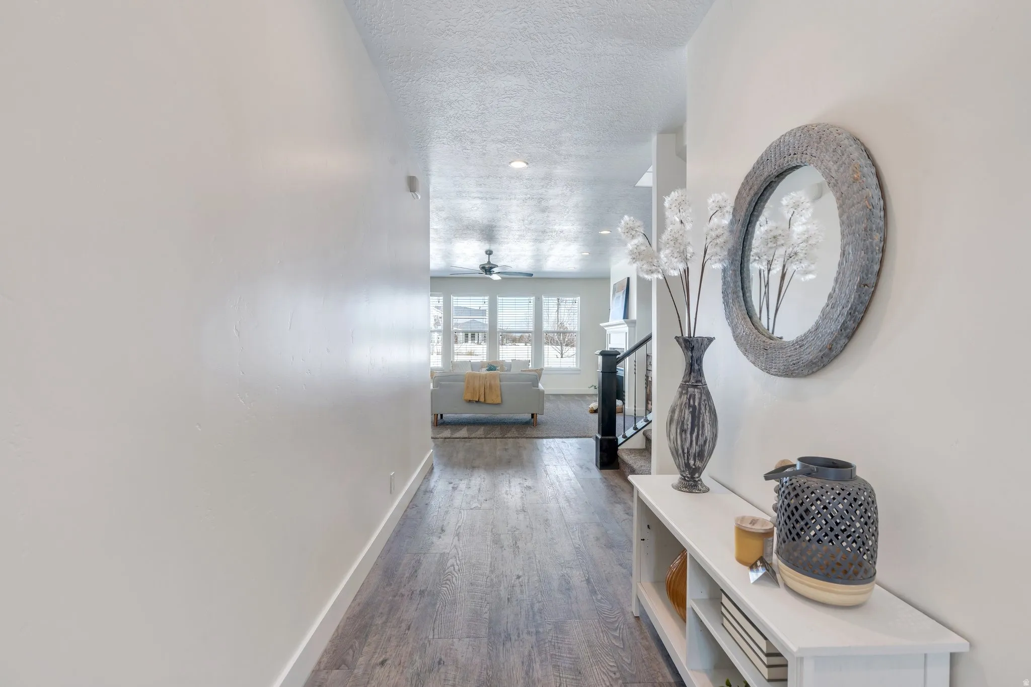 Hall with dark wood-style floors and a textured ceiling