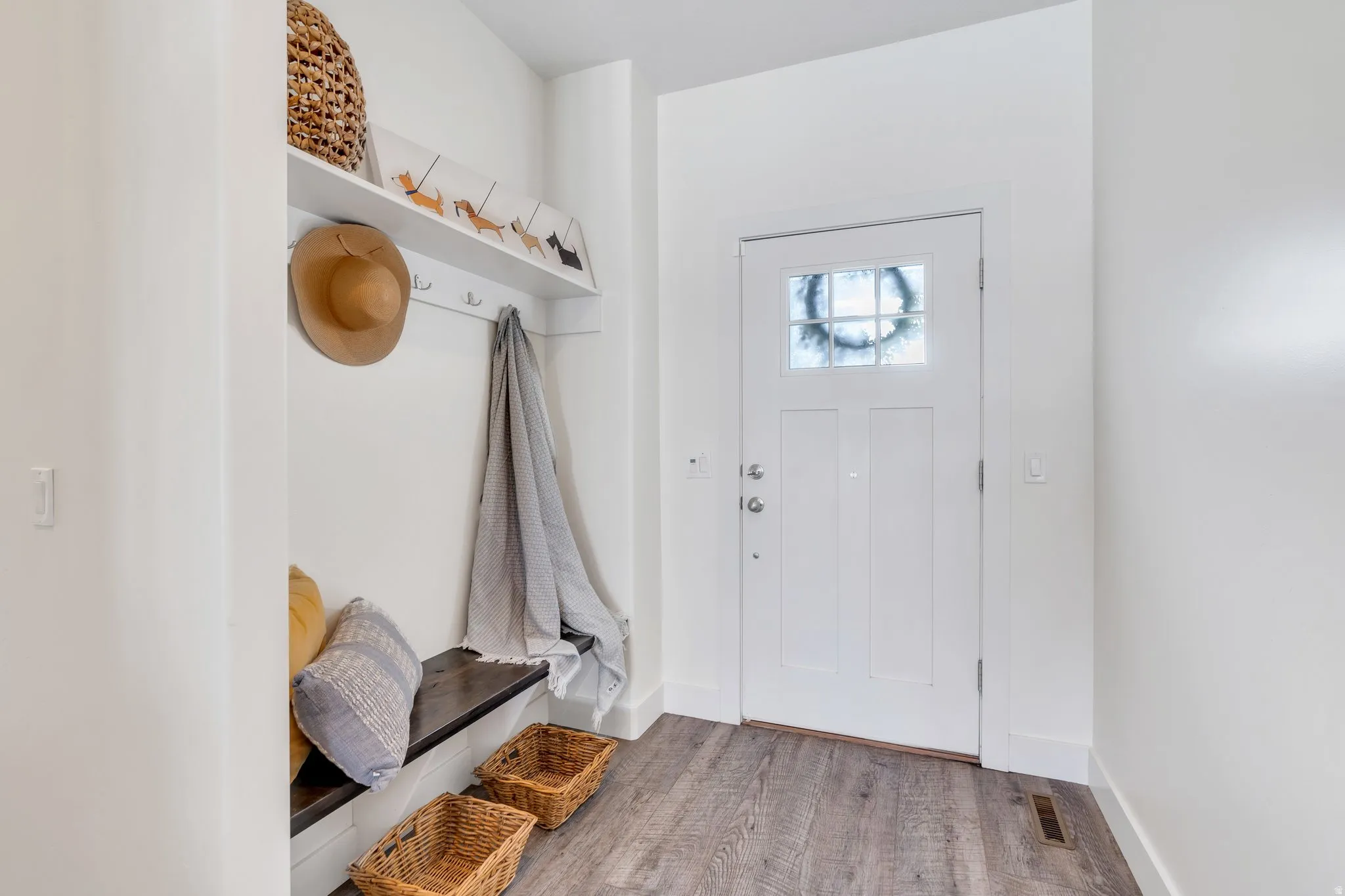 Mudroom with wood finished floors and baseboards